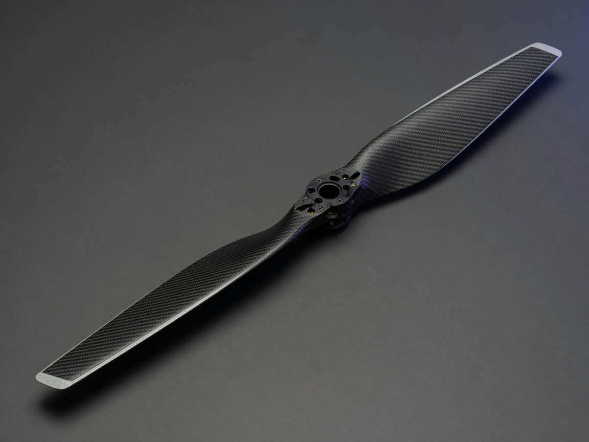 Large two-blade carbon fiber UAV propeller on a studio backdrop